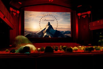 a cinema with a large screen displaying the paramount logo