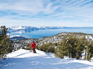 skier admires view of lake tahoe from the ski slope of heavenly mountain resor