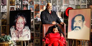 mona vaughn scott ,seated, the black repertory group’s executive director and artistic director, and her son, sean vaughn scott, the theater company’s development director, are flanked by photos of their parents and grandparents, respectively, the organization’s founders