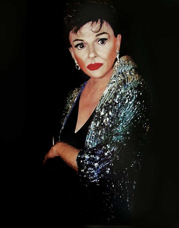 jim bailey as judy garland in full stage makeup and sequined dress.