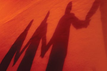 shadows of people holding hands