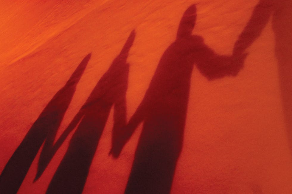 shadows of people holding hands