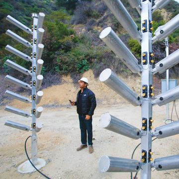 kerjon lee of the los angeles county department of public works examines cloud seeding trees, an automatic high output ground seeding system, at the kinneloa facility in pasadena