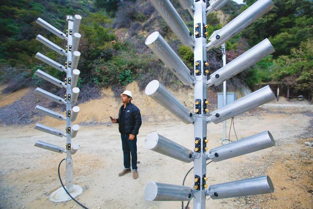 kerjon lee of the los angeles county department of public works examines cloud seeding trees, an automatic high output ground seeding system, at the kinneloa facility in pasadena