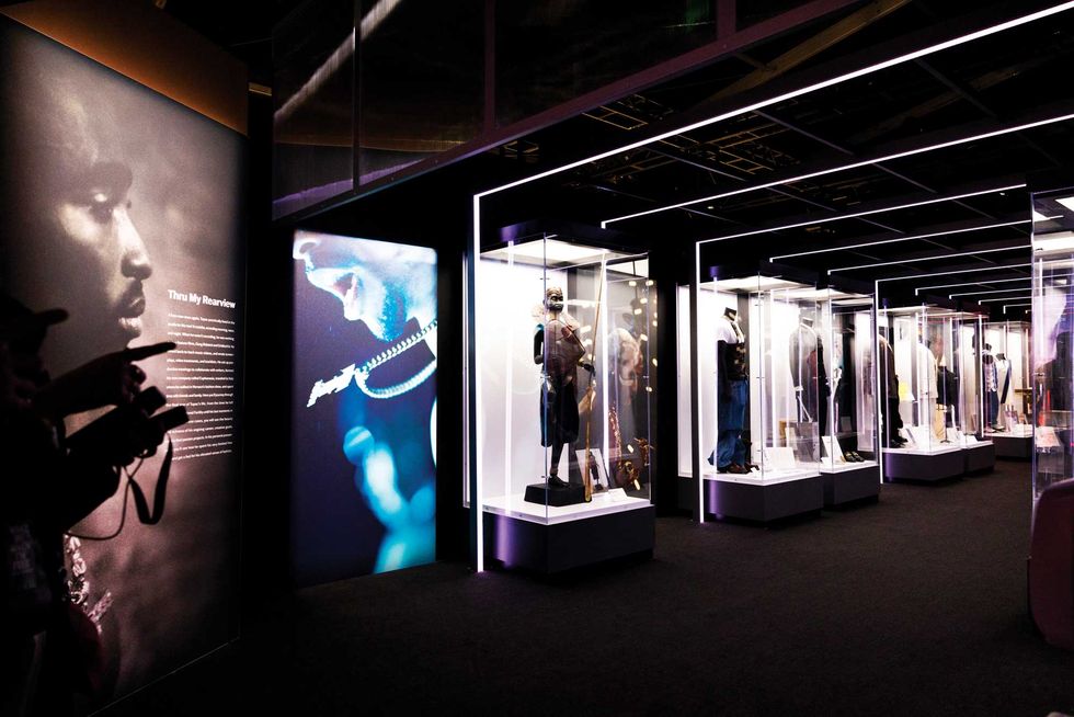 items from shakur’s wardrobe are displayed in a hall at the exhibit, a hybrid gallery installation multisensory experience