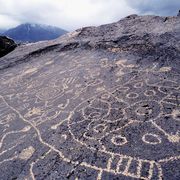 petroglyphs of paiute or shoshone origin near the owens valley in the eastern sierra, carved into volcanic tuff by chipping away the dark, top layer and exposing a light surface below
