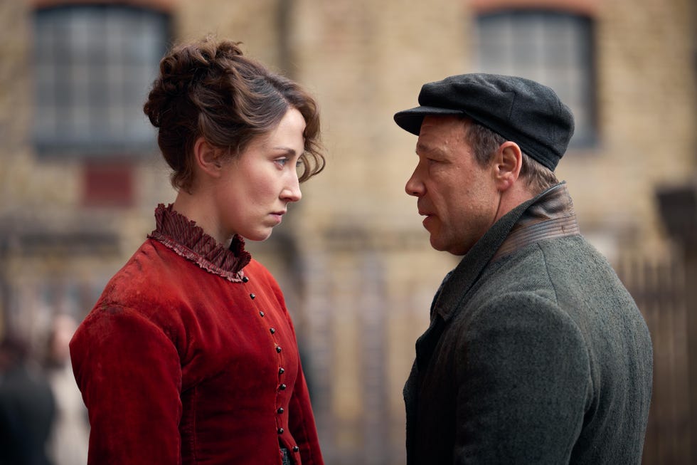 A confrontation between a woman in a red dress and a man in a dark coat and cap