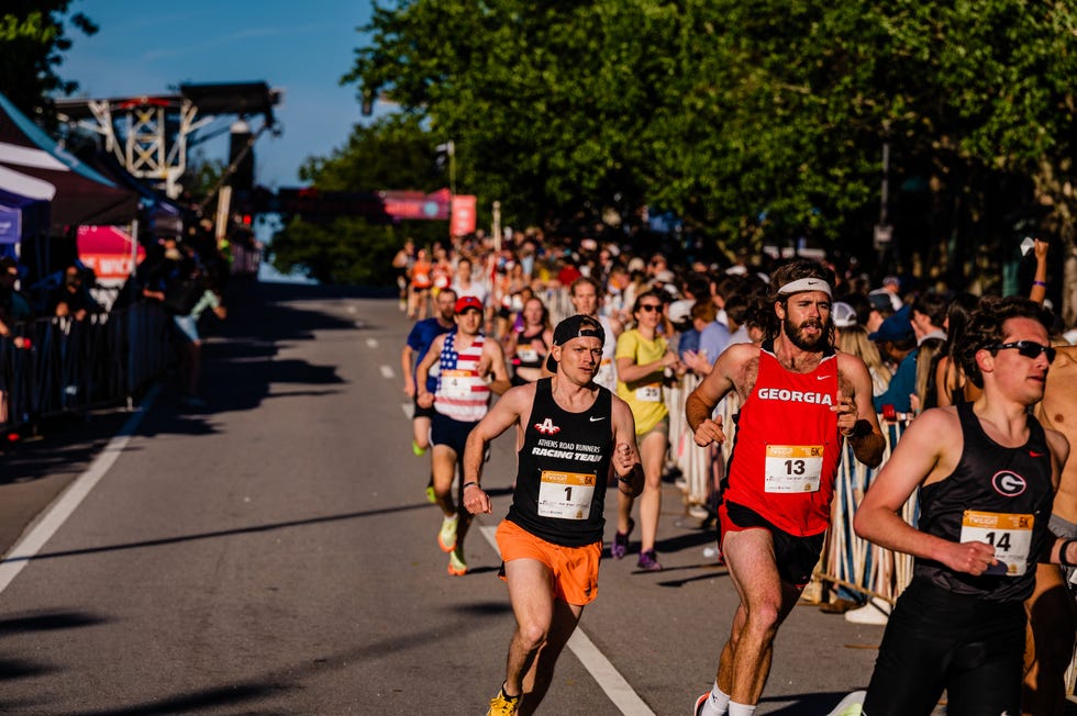 runners participating in a race with a cheering crowd