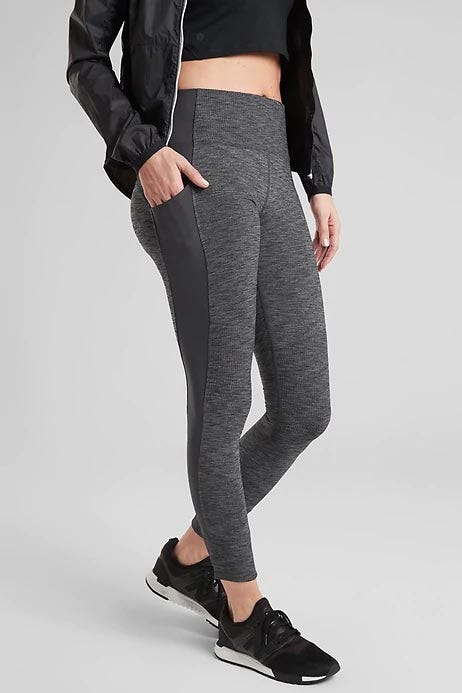a model shown from the waist down wearing gray leggings from athleta, good housekeeping's pick for best sustainable athleisure