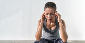 athlete fitness woman with headache migraine pain