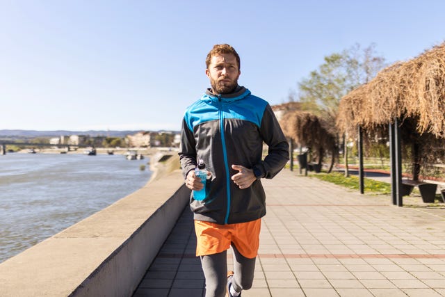 athlete jogging near the river