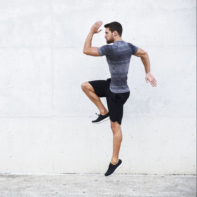 athlete jumping in front of white wall