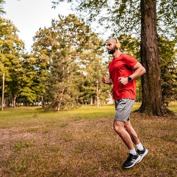 athlete man running in public park