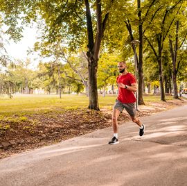 athlete man running in public park