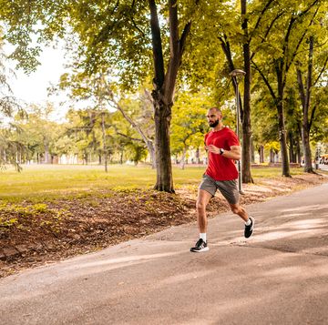 athlete man running in public park