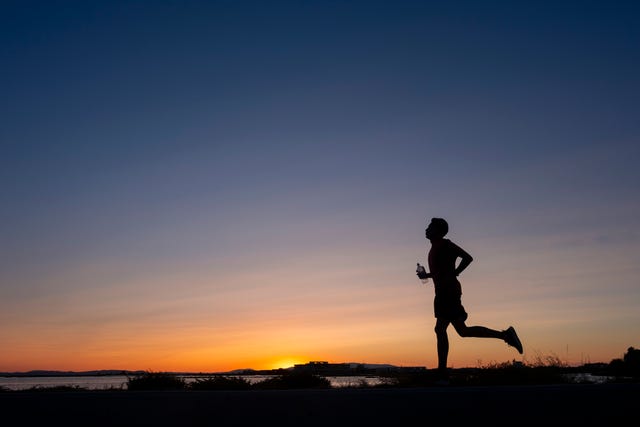 athlete trains at sunset on the seashore