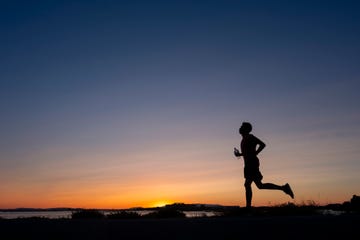 athlete trains at sunset on the seashore