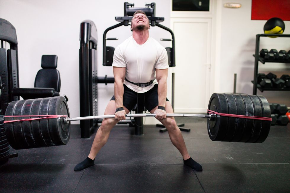 athletes lifting barbells exercise at gym