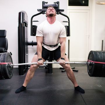 athletes lifting barbells exercise at gym
