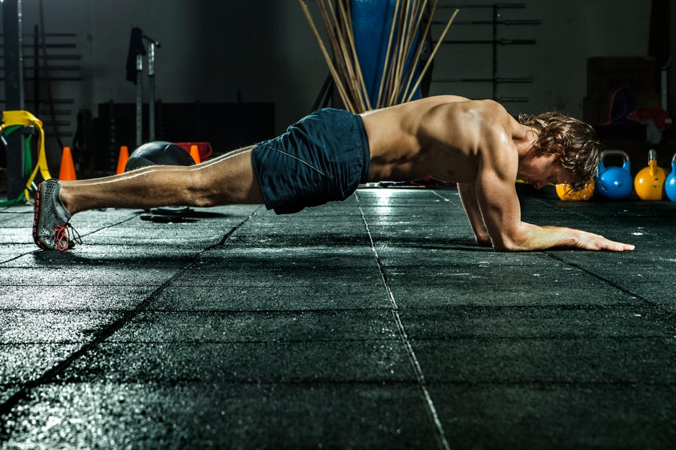 athletic man doing the plank for abs and core