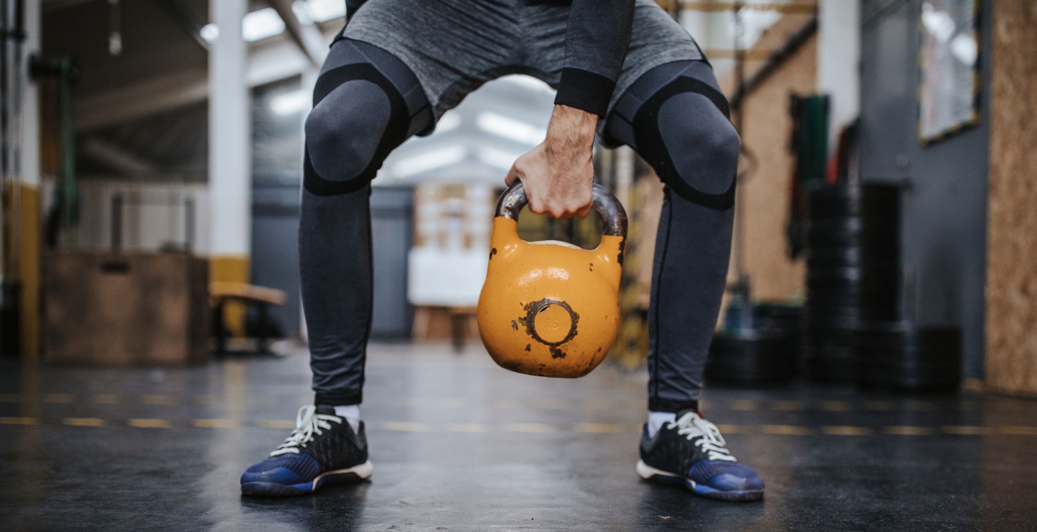 athletic man exercising with kettlebell