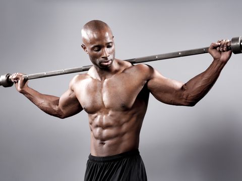 athletic man posing with a barbell
