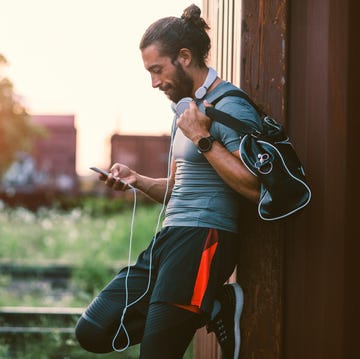 Athletic Man Using His Smart Phone.