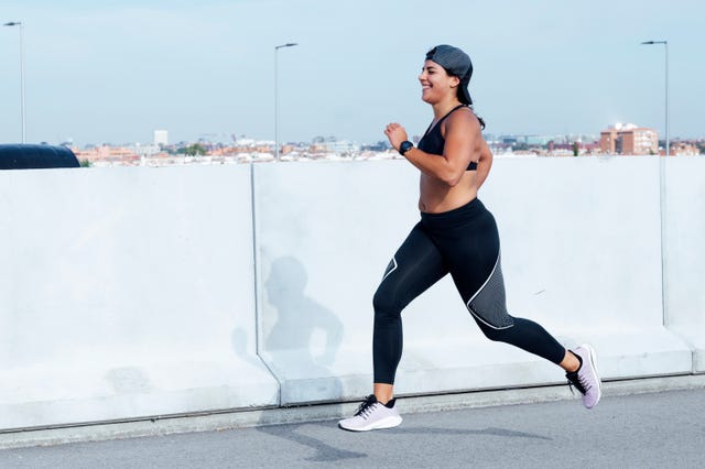 athletic woman running in the street
