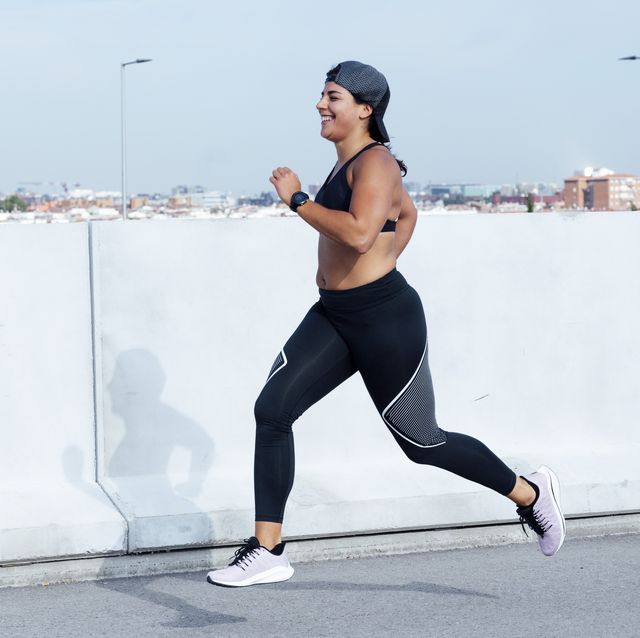 athletic woman running in the street