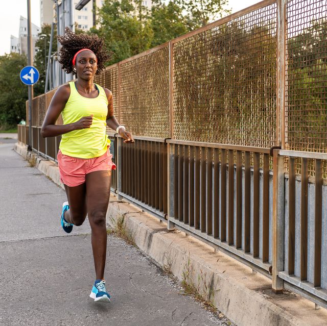 athletic woman running on street