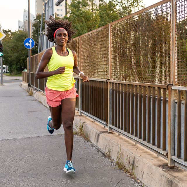 athletic woman STAR running on street