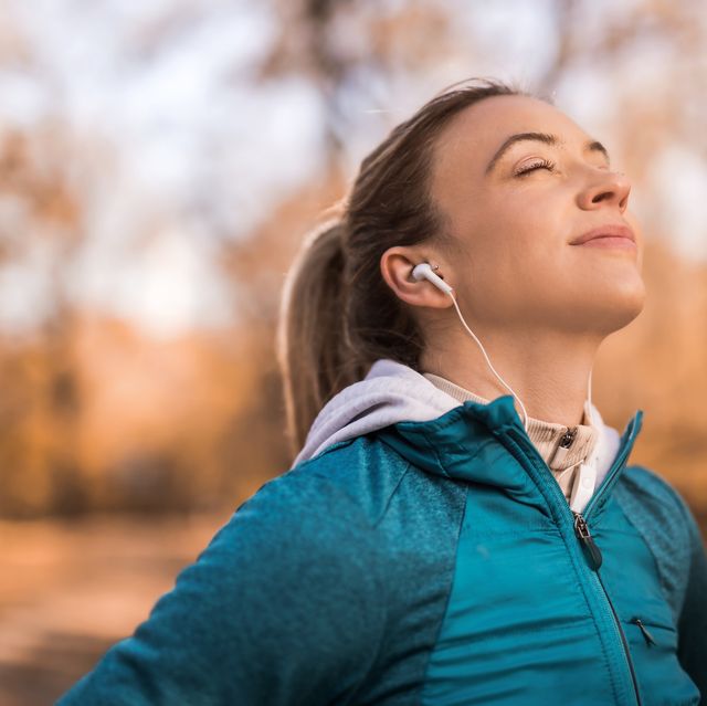 athletic young woman meditating outdoors on beautiful autumn morning