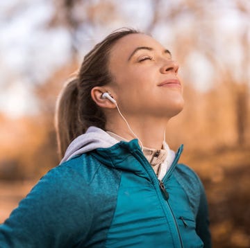 athletic young woman meditating outdoors on beautiful autumn morning