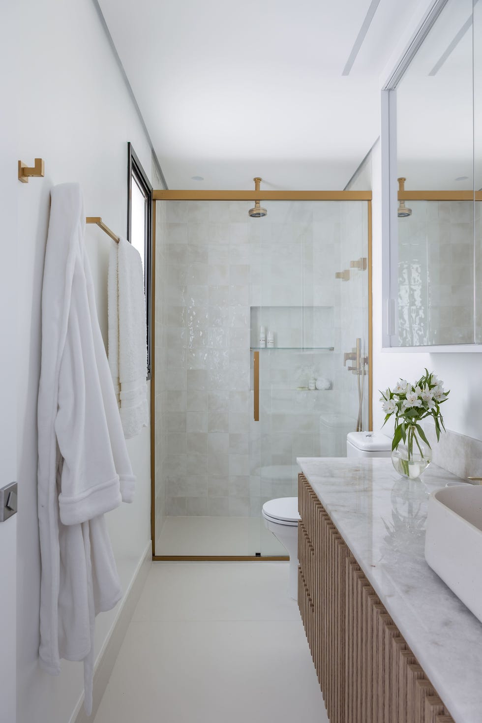 baño con ducha y mueble de lavabo volado con encimera de mármol