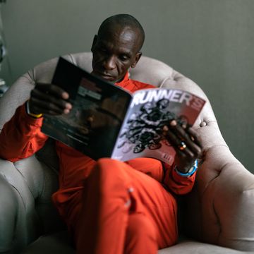 eulid kipchoge reads the newest issue of runners world featuring him on the cover