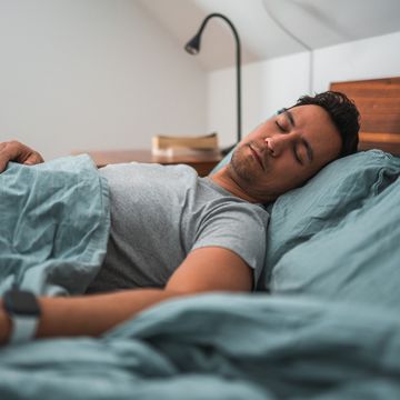 attractive multiracial man sleeping in bed in the morning