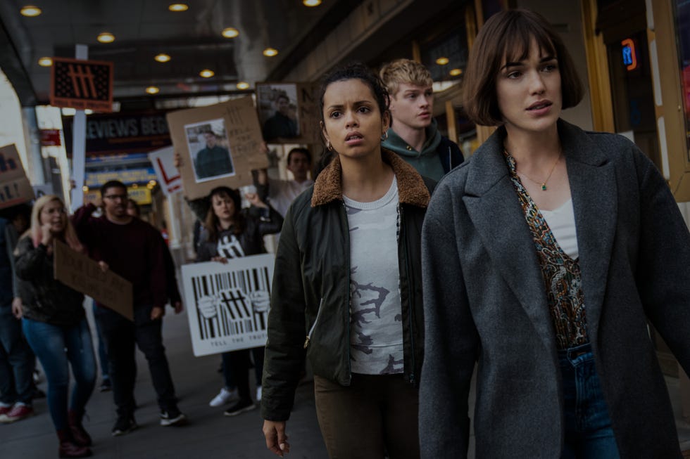 A group of protesters holding signs in a demonstration