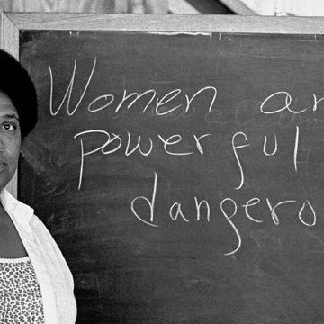 audre lorde lectures students at the atlantic center for the arts in new smyrna beach, florida next to a chalkboard that says women are powerful and dangerous