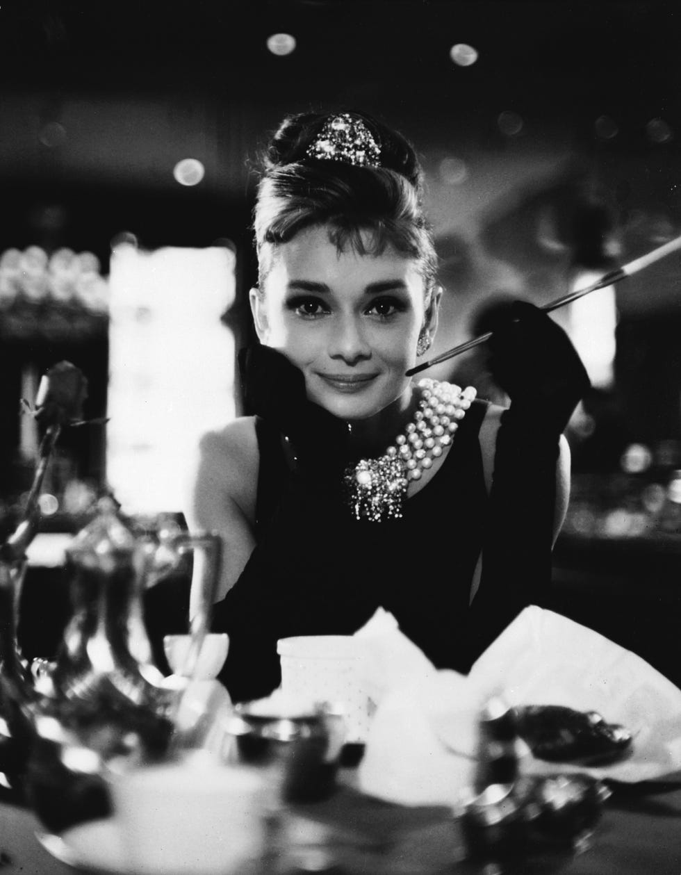 https://hips.hearstapps.com/hmg-prod/images/audrey-hepburn-wields-a-cigarette-holder-in-her-role-as-the-news-photo-1617655566.?resize=980:*