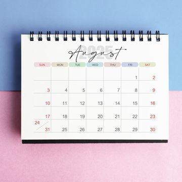 august desk calendar for 2025 year on blue and pink color background with shadow.