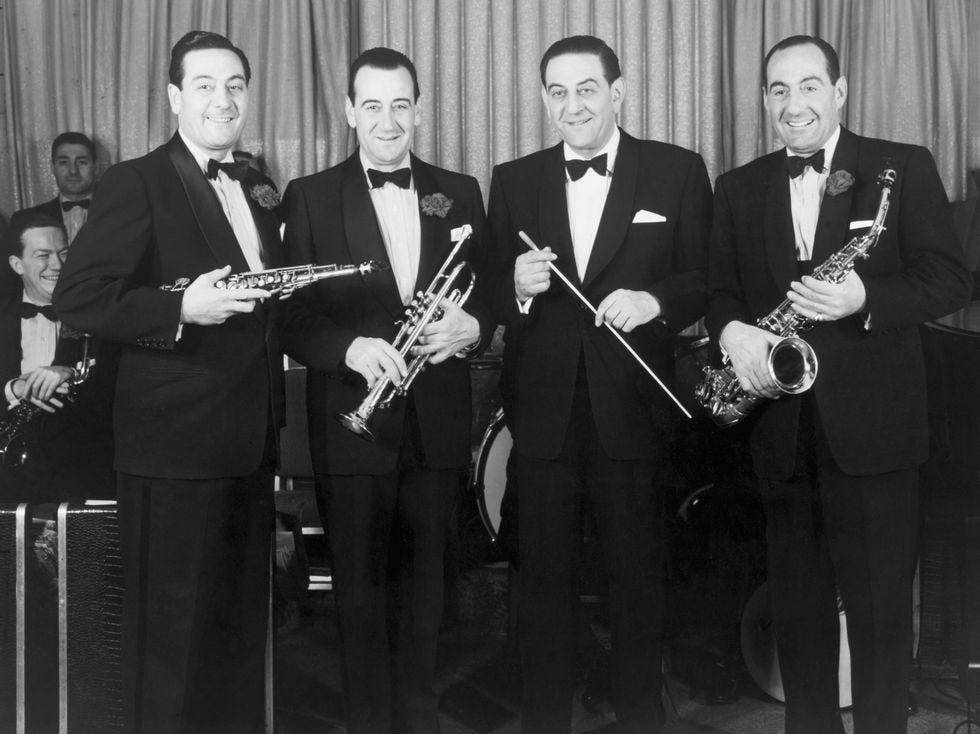 lombardo brothers who popularized auld lang syne, victor, lebert, guy, carmen with instruments, black and white vintage photo