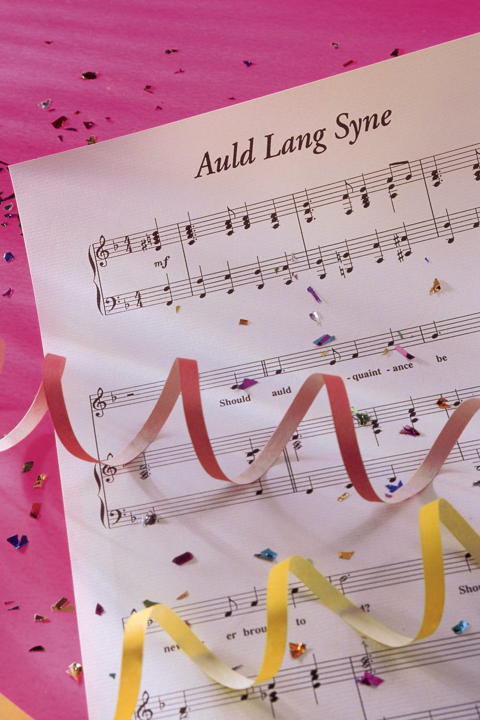 Auld Lang Syne sheet music with streamers and confetti