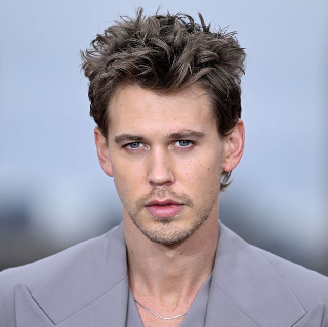 austin butler wearing a gray suit and looking ahead for a photograph