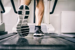 Austria, Klagenfurt, man running on treadmill