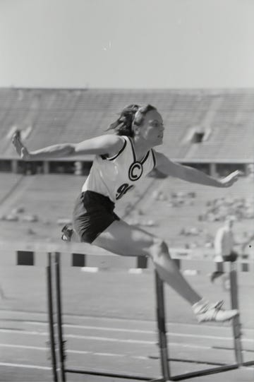 a person jumping over a bar