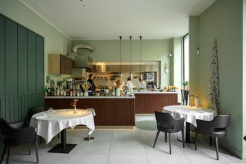 a kitchen with a bar and chairs