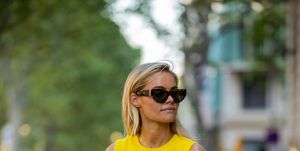 barcelona, spain   july 19 claire rose cliteur is seen wearing yellow sleeveless knit, grey pants, louis vuitton bag, sunglasses, heels during a summer street style shoot on july 19, 2022 in barcelona, spain photo by christian vieriggetty images
