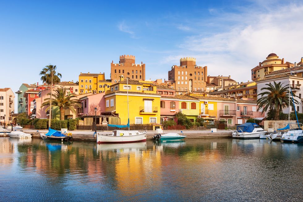 stock photograph of the colorful waterfront in port saplaya, valencia, spain on a sunny day