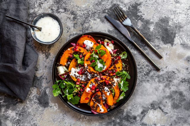 Autumnal salad with fried pumpkin, lentils, radicchio, pomegranate seeds, leaf salad and parsley with dressing