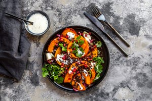 Autumnal salad with fried pumpkin, lentils, radicchio, pomegranate seeds, leaf salad and parsley with dressing